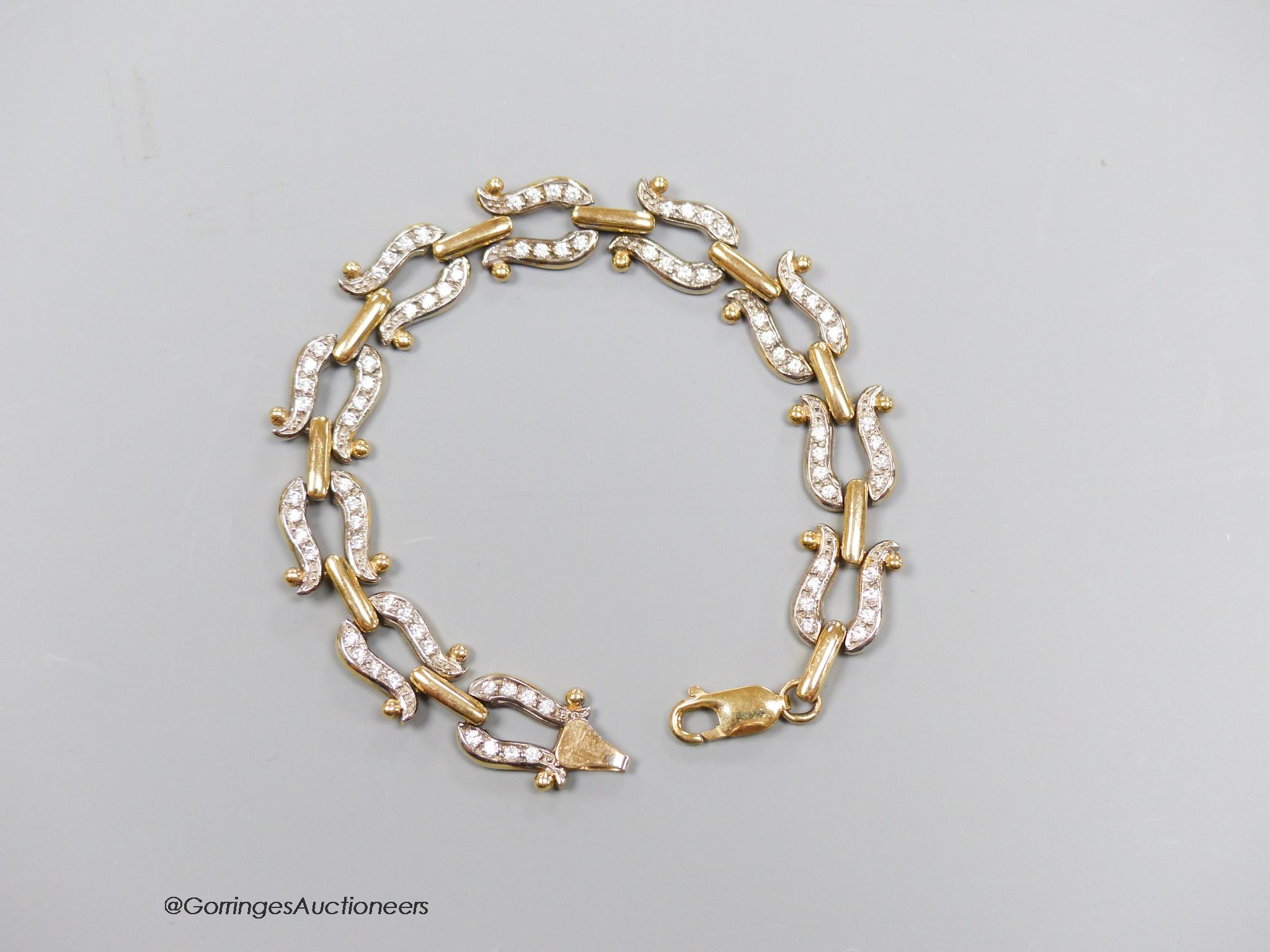 A 9ct gold and paste bracelet, with stylised horseshoe links, gross 19.9g, 19cm.